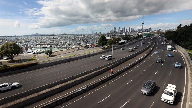 Vehicles travel along a road in Auckland.