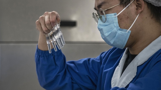 BEIJING, CHINA - SEPTEMBER 24: A worker checks syringes of the potential vaccine CoronaVac on the production line at Sinovac Biotech where the company is producing their potential COVID-19 vaccine CoronaVac during a media tour on September 24, 2020 in Beijing, China. Sinovacs inactivated vaccine candidate, called CoronaVac, is among a number of companies in the global race to control the coronavirus pandemic. The company is running Phase 3 human trials in four countries and ramping up production to 300 million doses per year at a new manufacturing facility south of Beijing. A lack of domestic coronavirus cases in China has meant that companies developing vaccines have shifted their focus overseas to conduct trials to gather the volume of data necessary to win regulatory approvals. When Chinas government launched an emergency use program in July to vaccinate groups of essential workers, Sinovacs chief executive says the company supplied tens of thousands of doses, even as trials are still underway. About 90% of Sinovacs employees have chosen to receive injections of CoronaVac, which is one of eight Chinese vaccine candidates in human trials. The company is also seeking approval to begin clinical trials with teenagers and children as young as age 3.(Photo by Kevin Frayer/Getty Images)