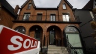 A "Sold" sign in front of a home in the Midtown neighborhood of Toronto, Ontario, Canada, on Thursday, March 11, 2021. The buying, selling and building of homes in Canada takes up a larger share of the economy than it does in any other developed country in the world, according to the Bank of International Settlements, and also soaks up a larger share of investment capital than in any of Canada’s peers.