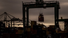 A crane lifts a shipping container at the Port of Oakland in Oakland, California.