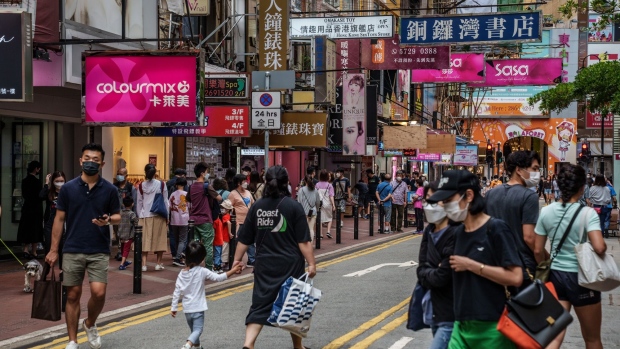 Pedestrians on the street in the Causeway Bay shopping area during its reopening in Hong Kong, China, on Saturday, May 7, 2022. Hong Kong is accelerating its reopening plans as Covid cases drop, easing mask-wearing rules and allowing more leisure venues to reopen, despite continued circulation of the pathogen that has led most rival financial hubs to live with the virus.