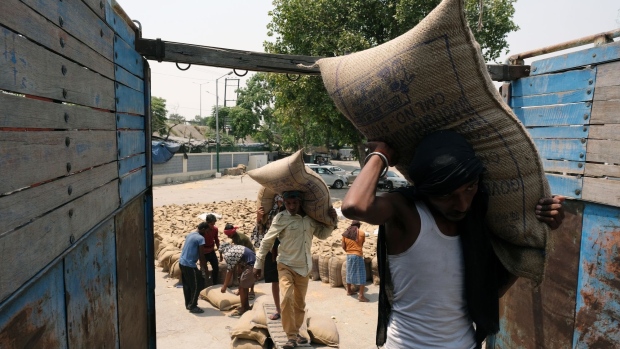 Laborers loading up wheat sacks on a truck at the grain market in the Khanna district of Punjab, India, on Saturday, April 30, 2022. A blistering heat wave has scorched what fields in India, reducing yields in the second-biggest grower and damping expectations for exports that the world is relying on to alleviate a global shortage.