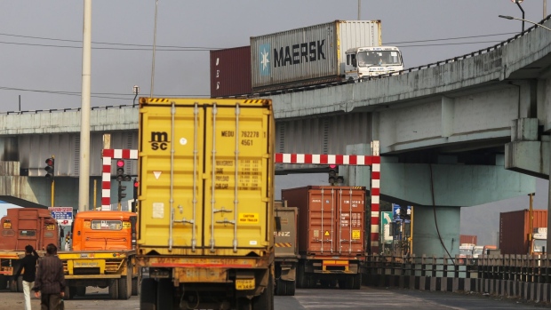 Trucks transporting shipping containers leave the Jawaharlal Nehru Port in Navi Mumbai, Maharashtra, India, on Sunday, Nov. 14, 2021. Congestion at many of the world’s major ports offered a snapshot of supply chains trying to avoid unprecedented bottlenecks, as cargo handlers searched for the quickest way to route goods through the clogged arteries of global commerce. Photographer: Dhiraj Singh/Bloomberg
