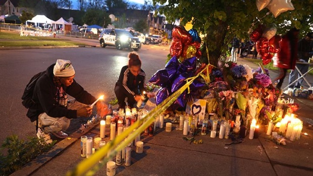 BUFFALO, NEW YORK - MAY 16: Mourners light candles at a makeshift memorial outside of Tops market on May 16, 2022 in Buffalo, New York. A gunman opened fire at the store yesterday killing ten people and wounding another three. The attack was believed to be motivated by racial hatred. (Photo by Scott Olson/Getty Images)