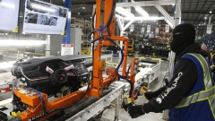An employee operates machinery to move an instrument panel at the Dakkota Integrated Systems manufacturing facility in Detroit, Michigan, U.S., on Thursday, May 5, 2022. Dakkota Integrated Systems is a Native American, Woman-Owned Company that manufactures Instrument Panels For Stellantis Jeep Assembly Plants.