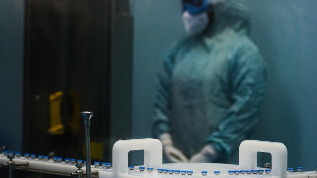 A worker dressed in personal protective equipment on the Johnson & Johnson Covid-19 vaccine production line at the Aspen Pharmacare Holdings Ltd. plant in Gqeberha, South Africa.