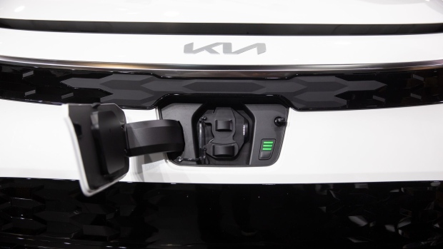 The charging port of a Kia Niro electric sports utility vehicle (SUV) during the 2022 New York International Auto Show (NYIAS) in New York, U.S., on Wednesday, April 13, 2022. The NYIAS returns after being cancelled for two years due to the Covid-19 pandemic.