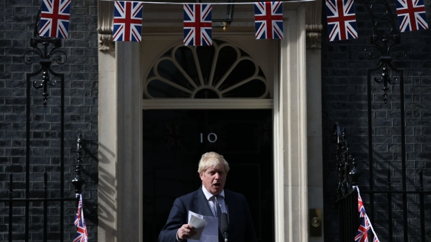 Boris Johnson, U.K. prime minister, speaks at a street market made up of small independent U.K. businesses in Downing Street in London, U.K., on Monday, May 9, 2022. Johnson plans to reset his U.K. premiership with a new legislative agenda after a damaging set of local elections, seeking to capitalize on a police investigation into whether his main political opponent broke the law during the pandemic lockdown. Photographer: Hollie Adams/Bloomberg