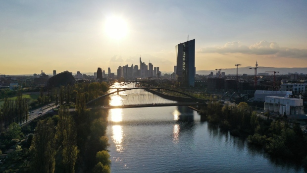 Sunlight reflects off the River Rhine near the European Central Bank (ECB) headquarters, right, and skyscrapers in the financial district in Frankfurt, Germany, on Tuesday, April 20, 2021. Financial markets around the world are waking up to the risks of another coronavirus flare-up.