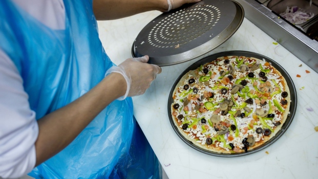 A chef prepares a pizza for a takeaway order in Riyadh, Saudi Arabia. Photographer: Tasneem Alsultan/Bloomberg