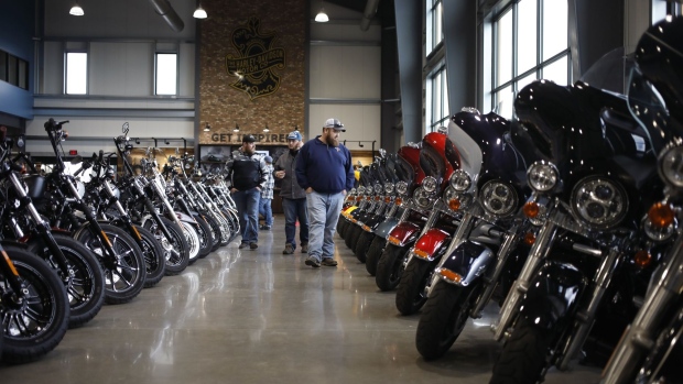 Customers walk past motorcycles at the Bluegrass Harley-Davidson dealership in Louisville, Kentucky, U.S., on Wednesday, Feb. 9, 2022. Harley-Davidson Inc. gained after reporting a surprise profit in the fourth quarter as strong demand in its home market and higher motorcycle prices padded earnings and shipping delays eased.