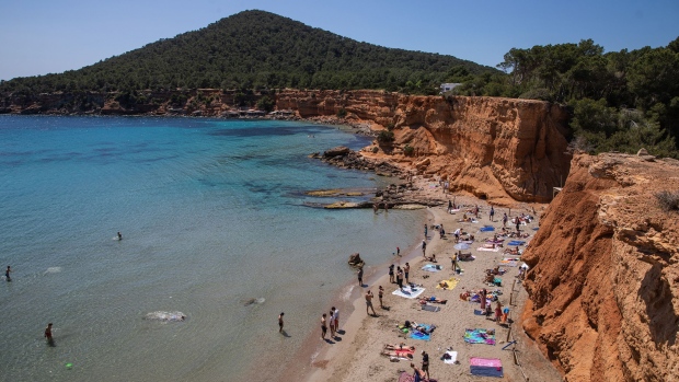 IBIZA, SPAIN - APRIL 29: Tourists enjoy Playa es Bol Nou beach on April 29, 2022 in Ibiza, Spain. The Spanish Mediterranean island of Ibiza, summer outpost for major European nightclubs, is preparing for the first summer season since the Covid-19 pandemic forced the island to close down. (Photo by Zowy Voeten/Getty Images)