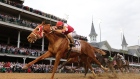 Rich Strike, ridden by jockey Sonny Leon, crosses the finish line to win the 148th running of The Kentucky Derby at Churchill Downs on May 7.