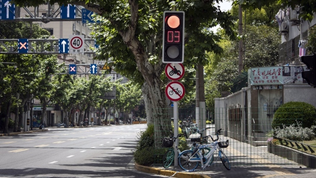 Bikes and a wired fence blocks access to a sidewalk during a lockdown due to Covid in Shanghai. Source: /Bloomberg