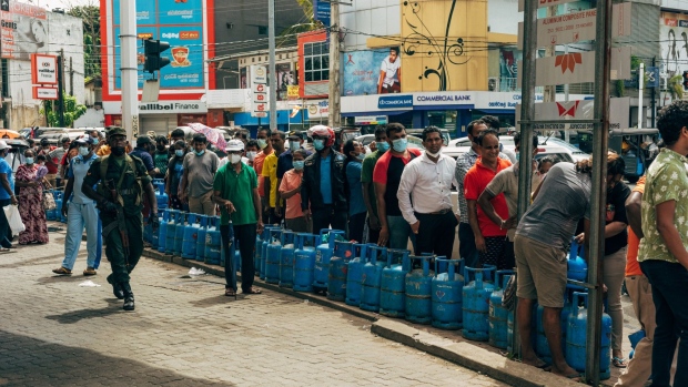 People wait in a queue for gas at the Pellawatte Litro Gas filling station in Colombo, Sri Lanka, on Sunday, May 22, 2022. Sri Lanka’s dollar bonds due July rebound after Friday’s drop, up almost 5 cents on the dollar in the biggest gain since October, as the government holds bailout talks with the IMF.