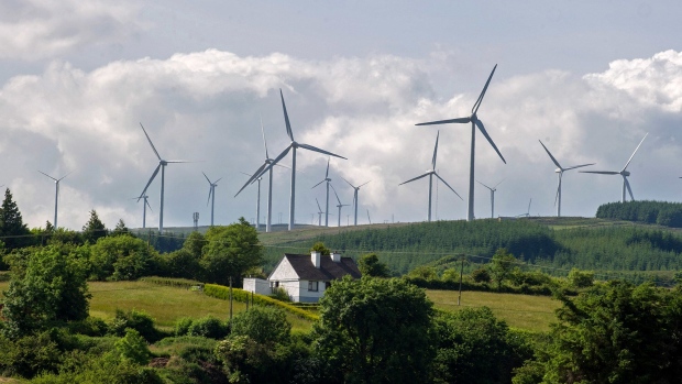 A house stands in the countryside near turbines that form the Seltannaveeny Wind Farm, operated by Energia Group, a unit of Viridian Group Ltd., near Arigna, Ireland, on Monday, July 8, 2013. Viridian Group, Northern Ireland's largest energy supplier, hired Macquarie Group Ltd. to advise on its bid for the retail and power generation unit of Irish state-owned gas company Bord Gais Eireann, people with knowledge of the matter said. Photographer: Bloomberg/Bloomberg