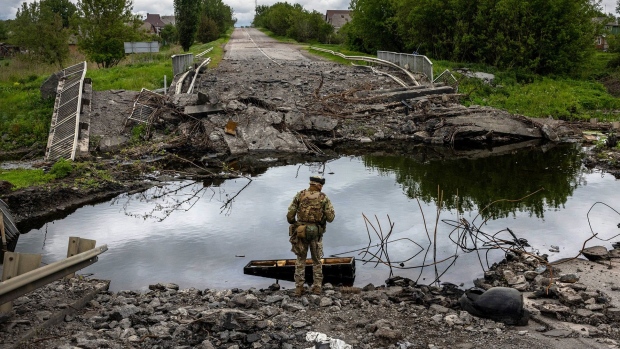 Ukrainian Territorial Defense soldiers patrol near the frontline near Ruska Lozova, Ukraine on May 22. 