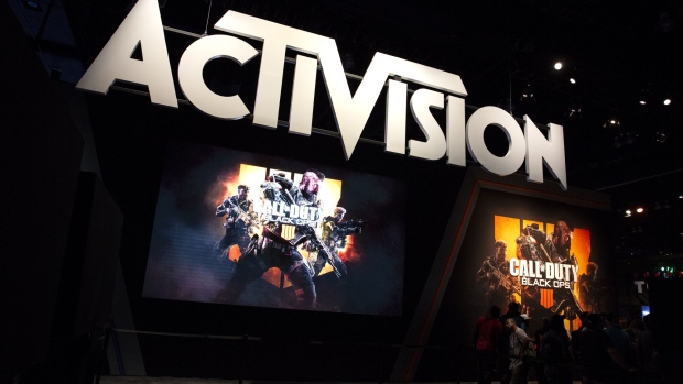 Attendees stand next to signage for Activision Blizzard Inc. Call Of Duty: Black Ops 4 video game during the E3 Electronic Entertainment Expo in Los Angeles. Photographer: Troy Harvey/Bloomberg