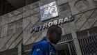 A pedestrian walks past Petroleo Brasileiro SA (Petrobras) headquarters in Rio de Janeiro, Brazil, on Monday, July 29, 2018. Jose Salim Mattar, the ministry of economy's privatizer-in-chief, is on a mission to sell over 100 state-controlled companies from electricity generators to the postal service to the government's crown jewels -- the nation's largest public enterprises including Petrobras. Photographer: Dado Galdieri/Bloomberg