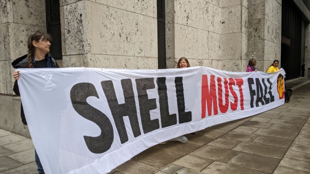 Extinction Rebellion environmental protesters hold a banner outside Shell’s offices in London on May 24. Photographer: Laura Hurst/Bloomberg