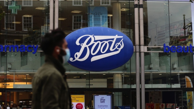 A pedestrian wearing a protective face mask passes a Boots pharmacists on Oxford Street in London.