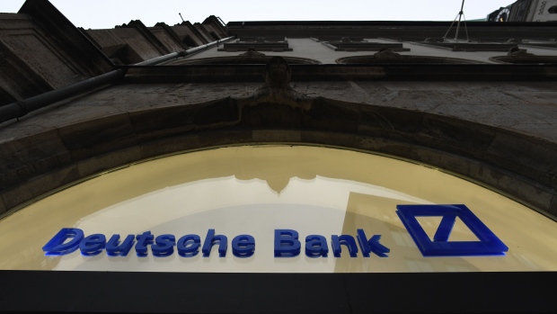 A logo on a Deutsche Bank AG bank branch in Munich, Germany, on Wednesday, Feb. 3, 2021. Deutsche Bank is scheduled to report fourth-quarter earnings on Thursday. Photographer: Andreas Gebert/Bloomberg