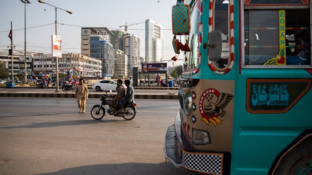 Vehicles drive through a commercial area in Clifton in Karachi, Pakistan, on Friday, Nov. 12, 2021. High global commodity prices, local fuel taxes and a weaker currency are all contributing to inflation hovering closer to the upper end of the central banks 7%-9% target range.