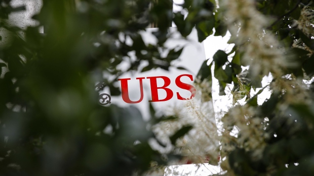 A sign sits on display outside a UBS Group AG bank branch in Worb, Switzerland, on Wednesday, July 15, 2020. U.S. President Donald Trump’s trade war with China is spurring UBS’s $2.2 billion multi-strategy hedge fund to make its biggest push yet into the Asian nation. Photographer: Stefan Wermuth/Bloomberg