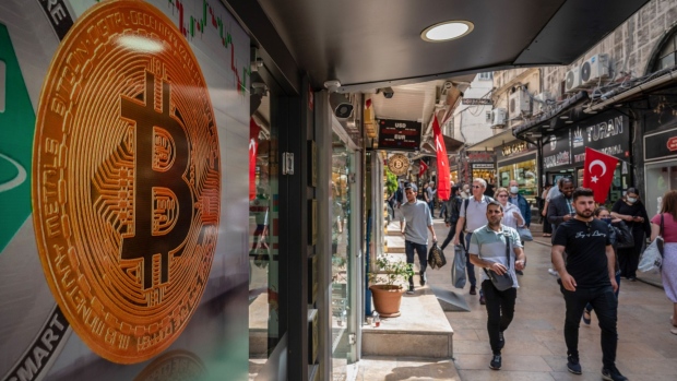 A Bitcoin logo in the window of a cryptocurrency exchange kiosk in Istanbul, Turkey, on Tuesday, April 26, 2022. Both tech stocks and Bitcoin have notched big swings this year as the Federal Reserve becomes less accommodative as part of its fight to combat inflation.