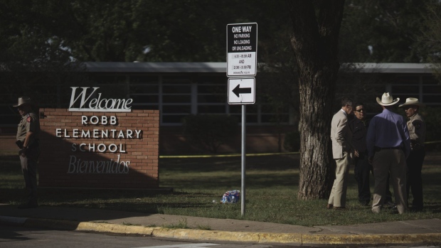 Law enforcement officers outside Robb Elementary School in Uvalde, Texas, US, on Tuesday, May 24, 2022. An 18-year-old gunman opened fire Tuesday at a Texas elementary school, killing at least 18 children, officials said, and the gunman was dead.