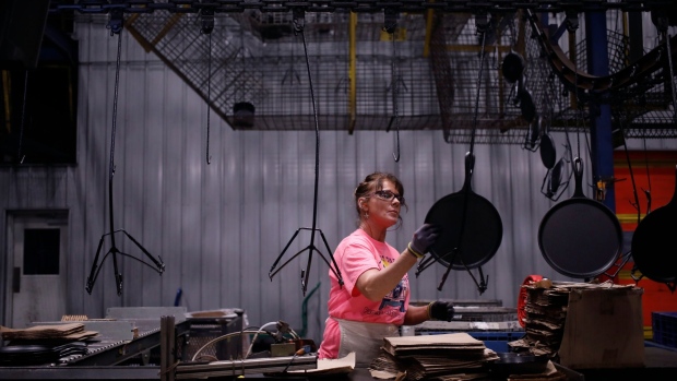 A worker packages cast iron cookware at a factory in South Pittsburg, Tennessee. Photographer: Luke Sharrett/Bloomberg