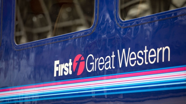 A logo sits on the carriage of First Great Western train service, operated by FirstGroup Plc, at London Paddington railway station in London, U.K., on Monday, April 16, 2018. British train and bus operator FirstGroup Plc said it rejected an "opportunistic" takeover proposal that private-equity firm Apollo Management made as the company struggles with under-performing rail routes in the U.K. and competition from discount airlines in the U.S.