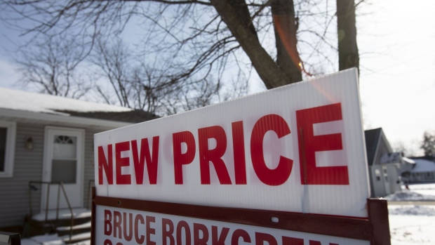 A "New Price" sign stands outside a home following a snow fall in Geneseo, Illinois, U.S., on Monday, Jan. 20, 2020. The National Association Of Realtors is scheduled to release Existing Homes Sales figures on January 22. Photographer: Daniel Acker/Bloomberg
