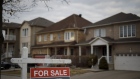 A "For Sale" sign in front of a row of homes in a subdivision in Vaughan, Ontario, Canada, on Thursday, March 11, 2021. The buying, selling and building of homes in Canada takes up a larger share of the economy than it does in any other developed country in the world, according to the Bank of International Settlements, and also soaks up a larger share of investment capital than in any of Canada’s peers. Photographer: Cole Burston/Bloomberg