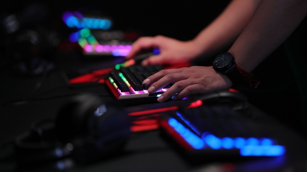 A gamer uses an illuminated keyboard to play a computer game at the Gamescom gaming industry event in Cologne, Germany, on Tuesday, Aug. 21, 2018. Photographer: Krisztian Bocsi/Bloomberg