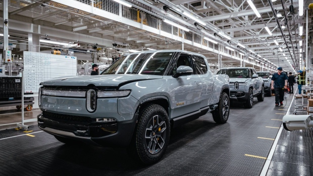 Rivian R1T electric vehicle (EV) pickup trucks on the assembly line at the company's manufacturing facility in Normal, Illinois, US., on Monday, April 11, 2022. Rivian Automotive Inc. produced 2,553 vehicles in the first quarter as the maker of plug-in trucks contended with a snarled supply chain and pandemic challenges.