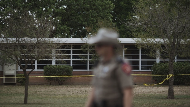 A Texas state trooper outside Robb Elementary School in Uvalde, Texas, US, on Tuesday, May 24, 2022. Fourteen students and one teacher were killed during a massacre in a Texas elementary school, the deadliest US school shooting in more than four years.
