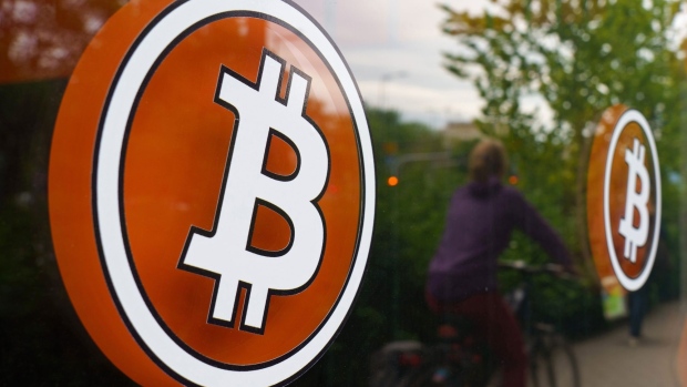 The bitcoin logo on the window of a cryptocurrency automated teller machine (ATM) kiosk in Warsaw, Poland, on Tuesday, May 24, 2022. A dramatic increase in the size and complexity of crypto markets means the sector is on track to become a risk for financial stability that must urgently be regulated, the European Central Bank said. Photographer: Piotr Malecki/Bloomberg