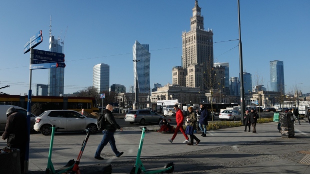Commuters walk along a street in central Warsaw, Poland, on Thursday, Nov. 25, 2021. Poland will temporarily cut taxes on electricity, gas and excise on fuel in a bid to help the central bank stem rising consumer prices that have become a hot topic among the ruling party’s electorate.