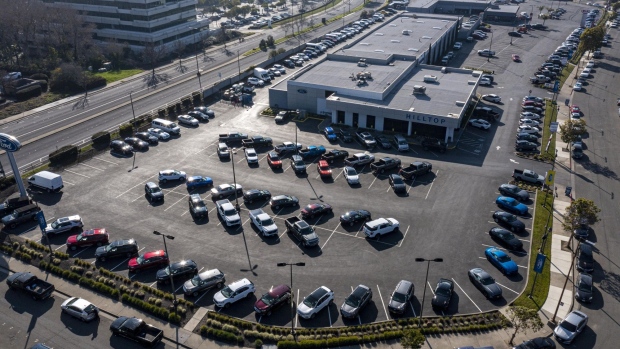 A Ford dealership in Richmond, California, U.S., on Wednesday, Jan. 26, 2022. U.S. auto sales will climb just 3.4% this year to 15.4 million cars and trucks as the semiconductor shortages continue to constrain vehicle inventory, auto dealers predict. Photographer: David Paul Morris/Bloomberg
