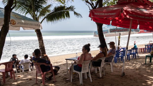 Foreign tourists on Kuta Beach in Bali, Indonesia, on Friday, May 6, 2022. With the broader reopening, fully vaccinated visitors from overseas to Bali no longer need to quarantine. Photographer: Putu Sayoga/Bloomberg