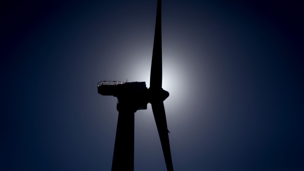 The silhouette of a GE-Alstom wind turbine is seen standing in the water off Block Island, Rhode Island, U.S., on Wednesday, Sept. 14, 2016. The installation of five 6-megawatt offshore-wind turbines at the Block Island project gives turbine supplier GE-Alstom first-mover advantage in the U.S. over its rivals Siemens and MHI-Vestas. Photographer: Eric Thayer/Bloomberg