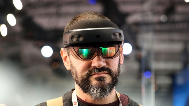 An attendee wears a Microsoft Corp. HoloLens 2 headset as he uses the Bentley Systems Inc. Synchro XR augmented reality (AR) app, at the Microsoft Corp. stand on the opening day of the MWC Barcelona in Barcelona, Spain, on Monday, Feb. 25, 2019. At the wireless industry’s biggest conference, over 100,000 people are set to see the latest innovations in smartphones, artificial intelligence devices and autonomous drones exhibited by more than 2,400 companies.