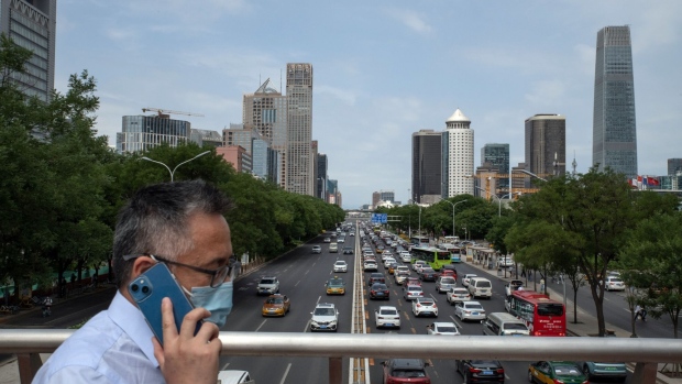 Vehicles travel along a road in Beijing, China, on Tuesday, June 7, 2022. As Beijing relaxes Covid curbs and allows indoor dining again, restaurants are betting that customers will be back in droves, boosting demand for everything from meat to cooking oils.