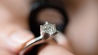 An employee inspects a used diamond ring inside the Komehyo Co. jewelry store in the Shinjukuo district of Tokyo, Japan, on Friday, May 15, 2015. As the population shrinks and the number of retirees grows, Japan is seeing the market for second-hand goods expand as people unload luxury items acquired during the boom years. Photographer: Akio Kon