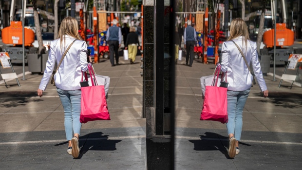A pedestrian carries shopping bags in San Francisco, California. Photographer: David Paul Morris/Bloomberg