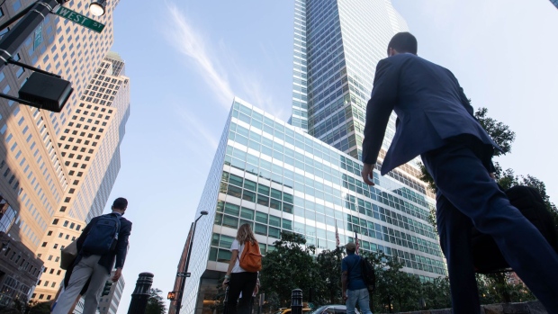 Office workers walk near the Goldman Sachs Group Inc. headquarters in New York, U.S., on Thursday, July 22, 2021. After a year of Zoom meetings and awkward virtual happy hours, New York's youngest aspiring financiers have returned to the offices of the city's investment banks, where they're making the most of the in-person mentoring and networking they've lacked during the pandemic.