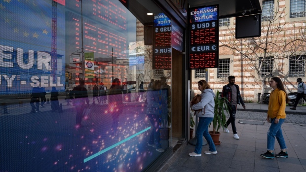 An electronic board displays exchange rates information outside a currency exchange bureau in Istanbul, Turkey, on Thursday, April 21, 2022. Turkish inflation soared to a fresh two-decade high in March, leaving the lira increasingly vulnerable by depriving the currency of a buffer against market selloffs.