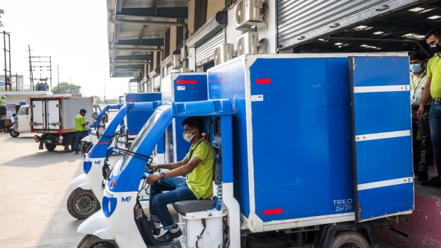 A delivery rider in a Mahindra Treo Zor electric vehicle departs a loading bay at a BigBasket warehouse in Noida, Uttar Pradesh, India. Photographer: Prashanth Vishwanathan/Bloomberg
