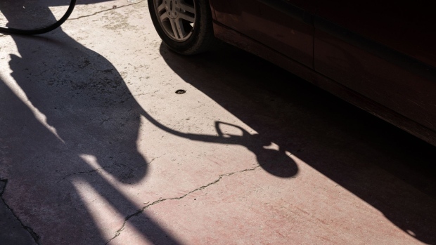 The shadow of a gas nozzle during refueling at a gas station in Thessaloniki, Greece, on Tuesday, March 22, 2022. Oil pushed higher ahead of high-level meetings that may result in fresh sanctions on Russia, and as storm damage to a vital Black Sea export terminal compounded supply risks. Photographer: Konstantinos Tsakalidis/Bloomberg